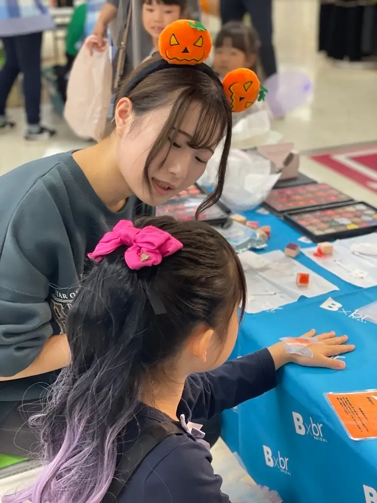 女性が子供にボディージュエリーを施している